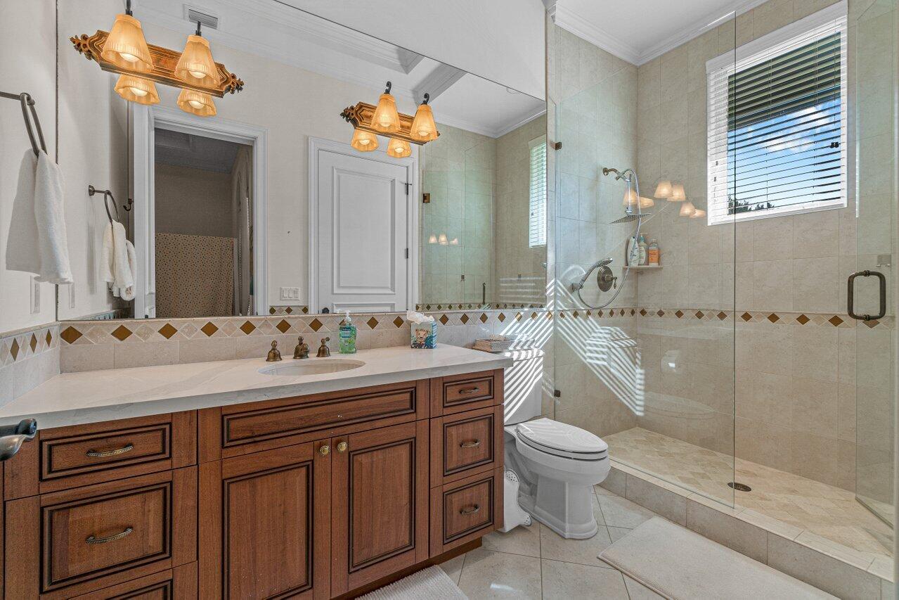 6103 North Ocean Boulevard Ocean Ridge, FL 33435 - Photo 16 of 53 a bathroom with a sink a toilet and shower
