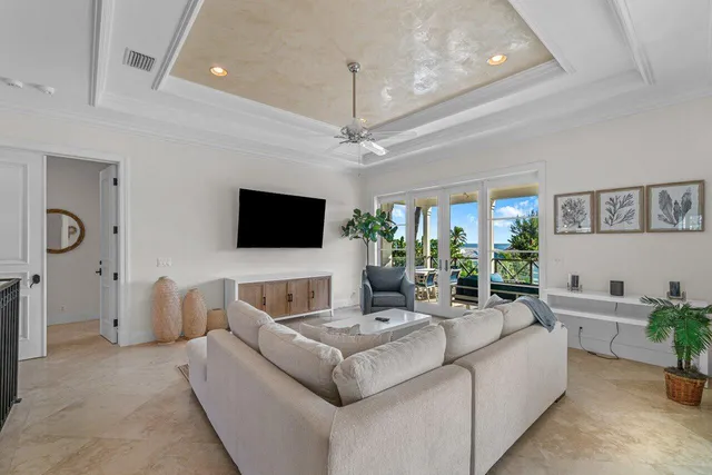 a living room with furniture a chandelier and a rug