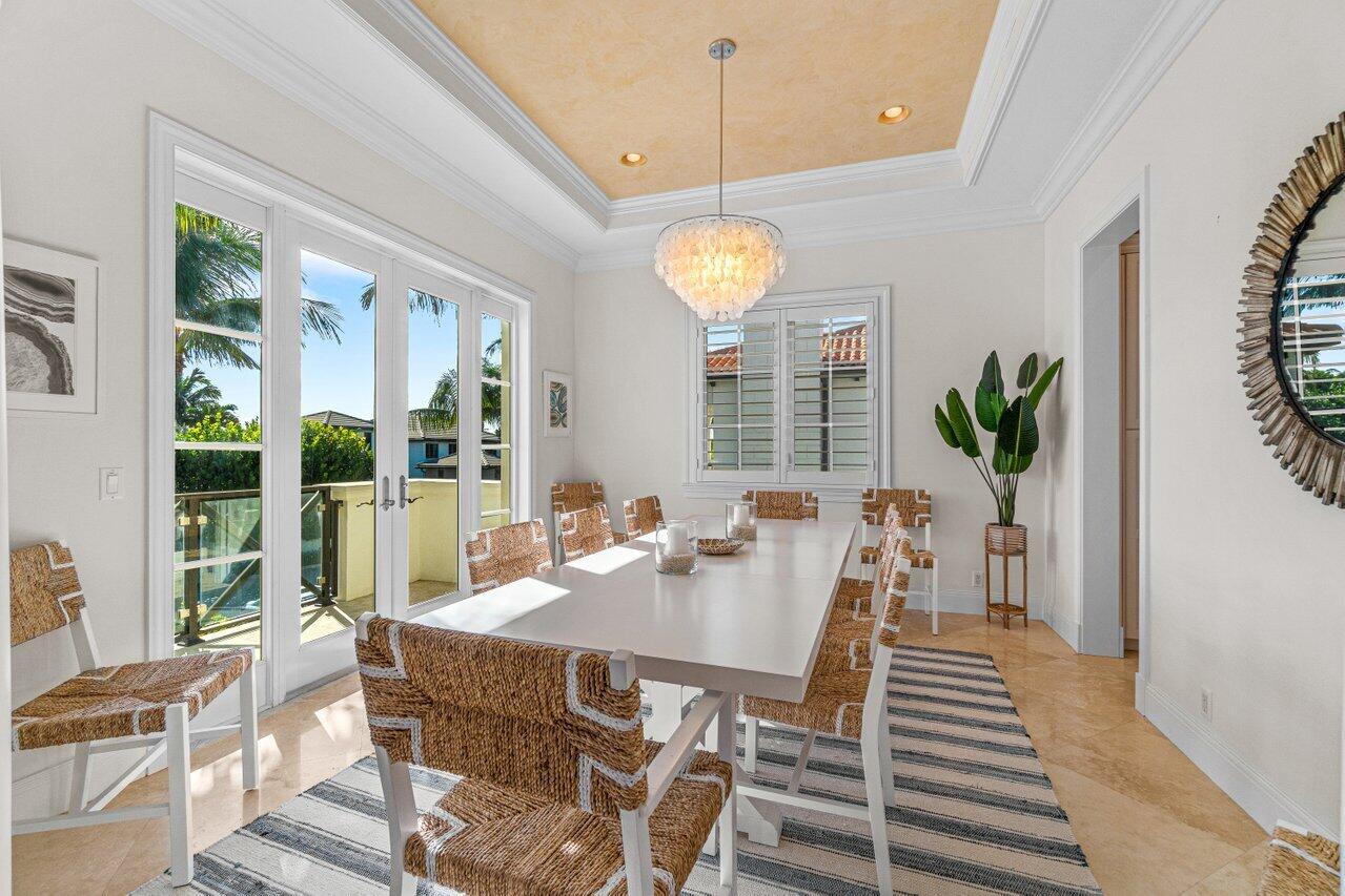 6103 North Ocean Boulevard Ocean Ridge, FL 33435 - Photo 20 of 53 a view of a dining room with furniture wooden floor and chandelier