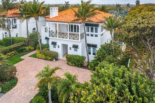 an aerial view of a house with a yard and potted plants