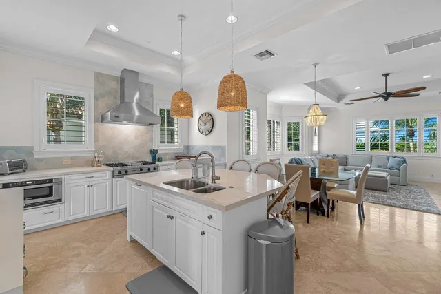 a kitchen with a table chairs sink and cabinets