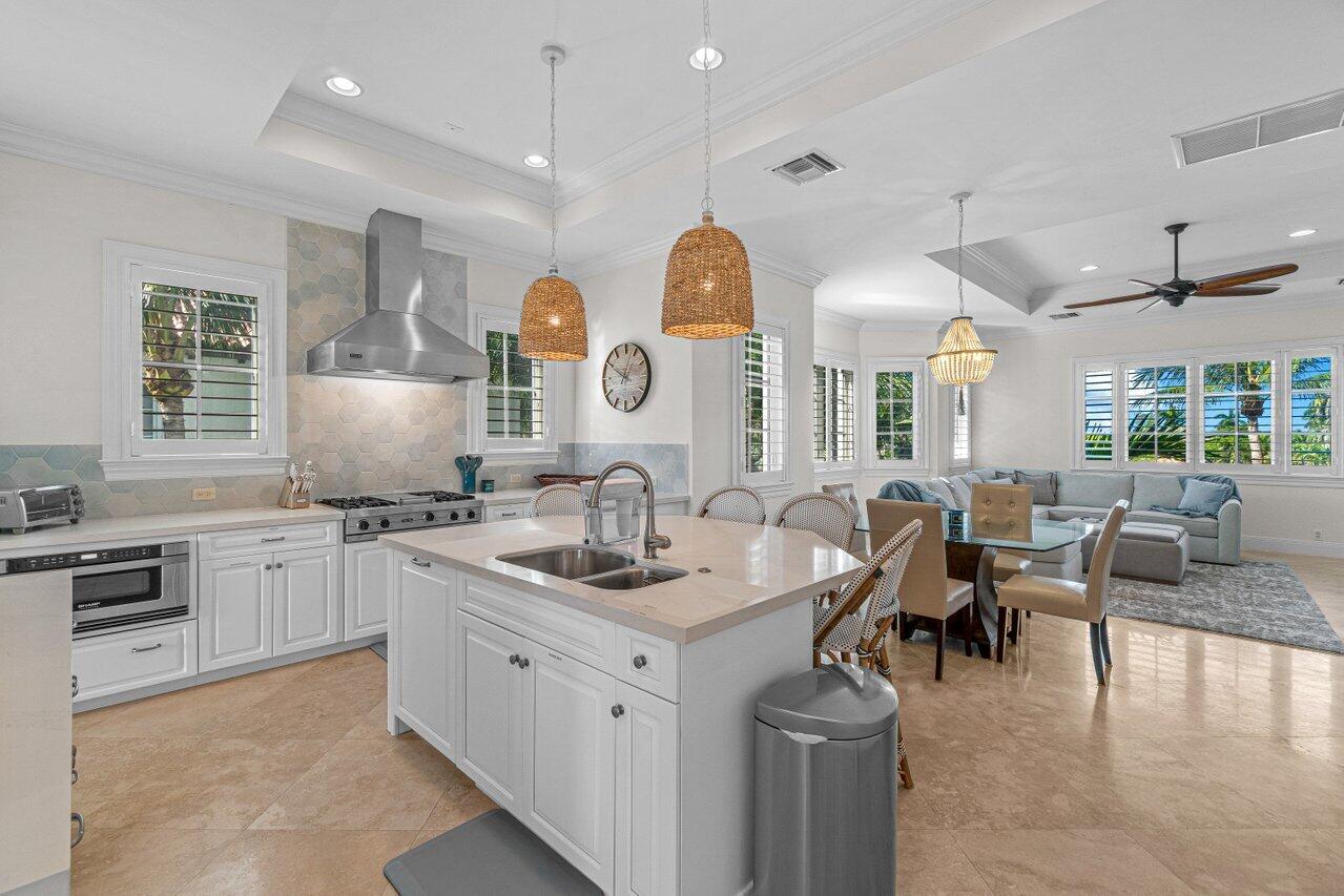 6103 North Ocean Boulevard Ocean Ridge, FL 33435 - Photo 21 of 53 a open kitchen with stainless steel appliances granite countertop a stove and white cabinets
