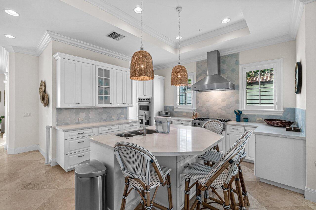 6103 North Ocean Boulevard Ocean Ridge, FL 33435 - Photo 22 of 53 a kitchen with a table chairs sink and cabinets