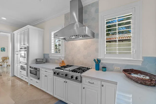 a view of a dining room with furniture and a chandelier