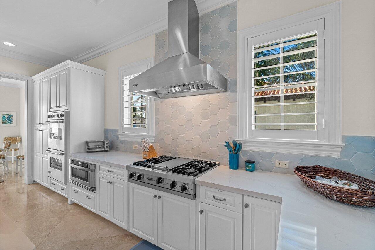 6103 North Ocean Boulevard Ocean Ridge, FL 33435 - Photo 23 of 53 a kitchen with stainless steel appliances a stove a sink and a refrigerator