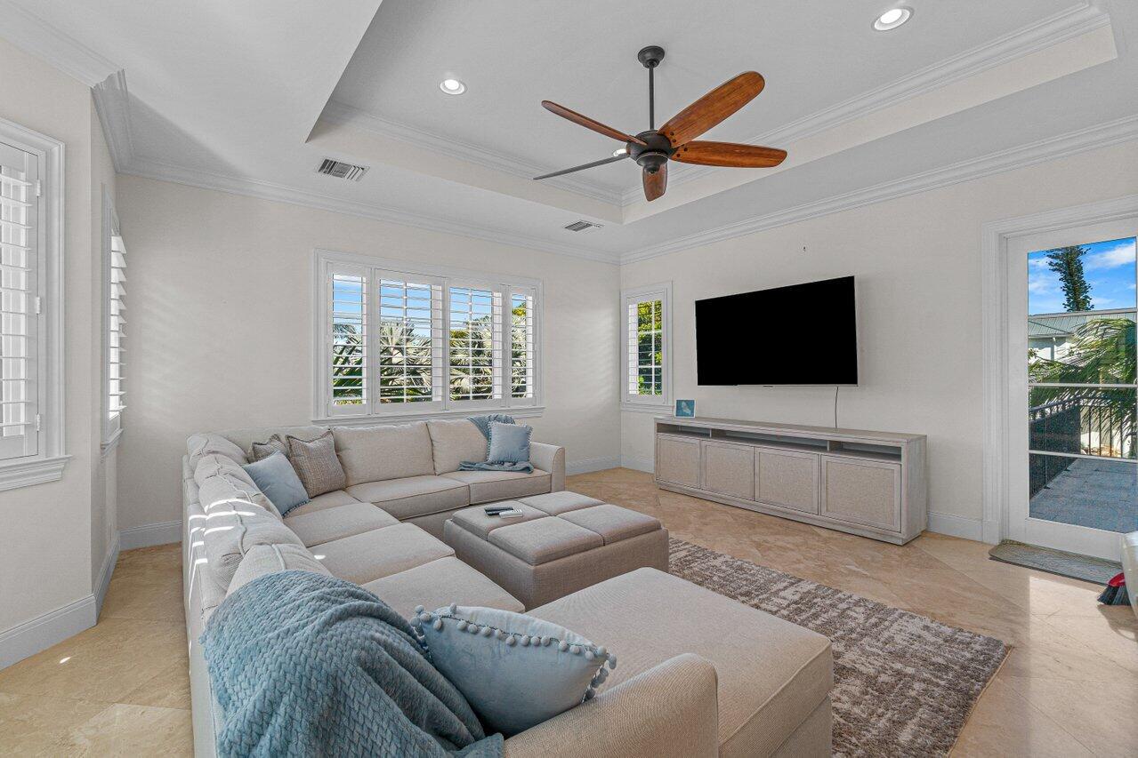 6103 North Ocean Boulevard Ocean Ridge, FL 33435 - Photo 25 of 53 a living room with furniture and a flat screen tv