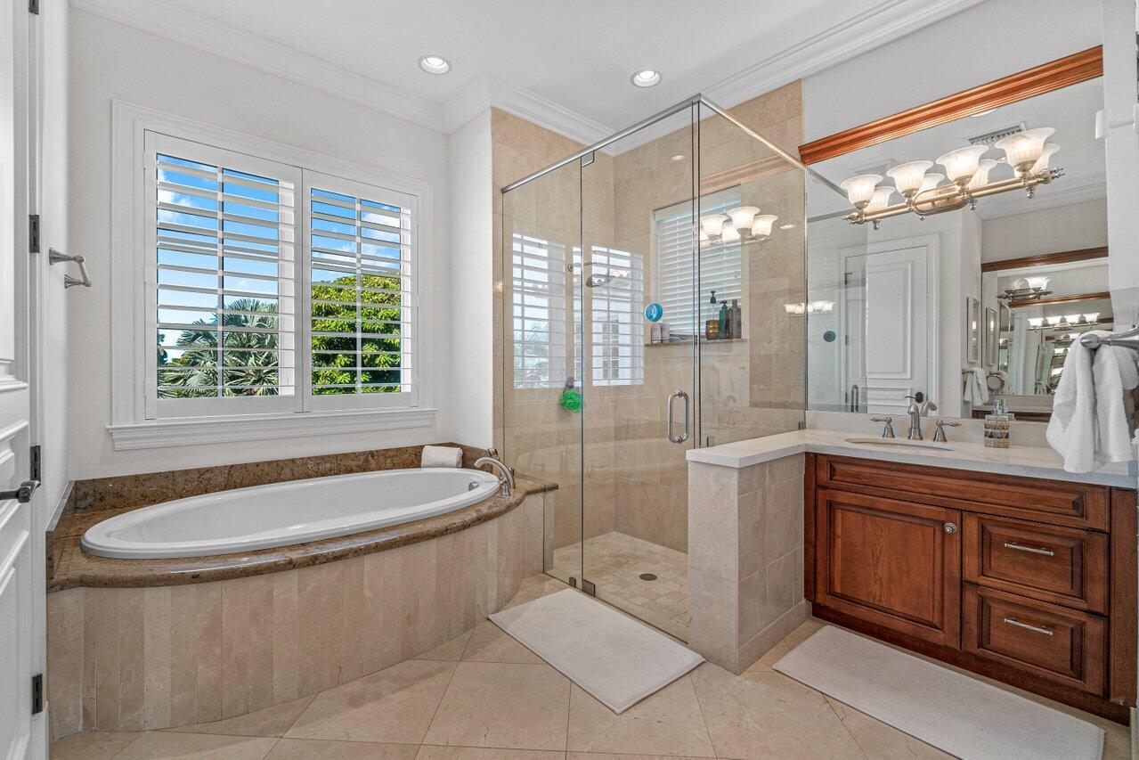 6103 North Ocean Boulevard Ocean Ridge, FL 33435 - Photo 31 of 53 a spacious bathroom with a tub sink shower and mirror