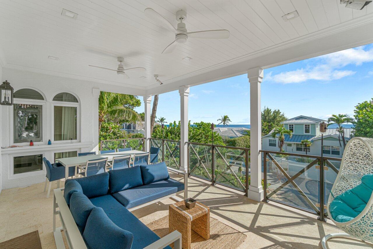 6103 North Ocean Boulevard Ocean Ridge, FL 33435 - Photo 33 of 53 a living room with furniture and a floor to ceiling window