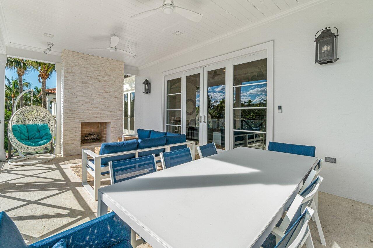 6103 North Ocean Boulevard Ocean Ridge, FL 33435 - Photo 36 of 53 a living room with furniture a fireplace and a floor to ceiling window