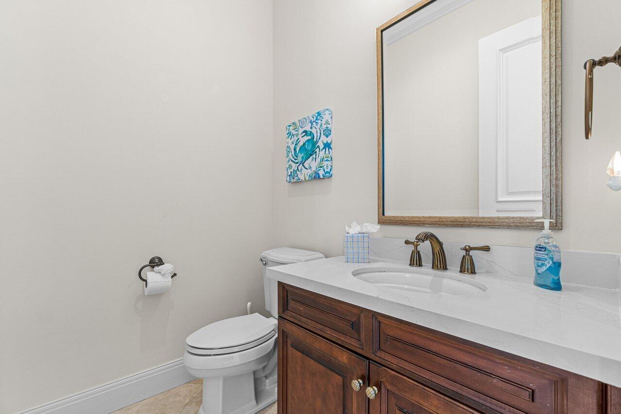 6103 North Ocean Boulevard Ocean Ridge, FL 33435 - Photo 38 of 53 a bathroom with a sink a toilet and a mirror