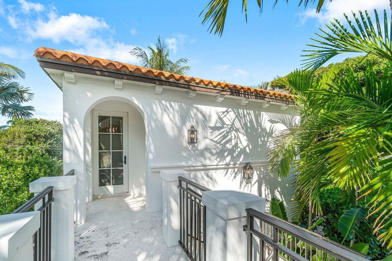 6103 North Ocean Boulevard Ocean Ridge, FL 33435 - Photo 39 of 53 a front view of a house with a garage