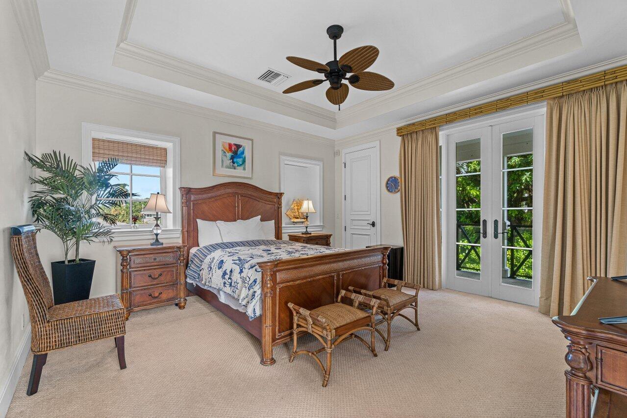 6103 North Ocean Boulevard Ocean Ridge, FL 33435 - Photo 40 of 53 a bedroom with a bed and a chair