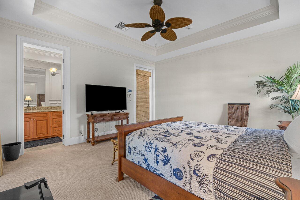 6103 North Ocean Boulevard Ocean Ridge, FL 33435 - Photo 41 of 53 a bedroom with a bed and a flat screen tv