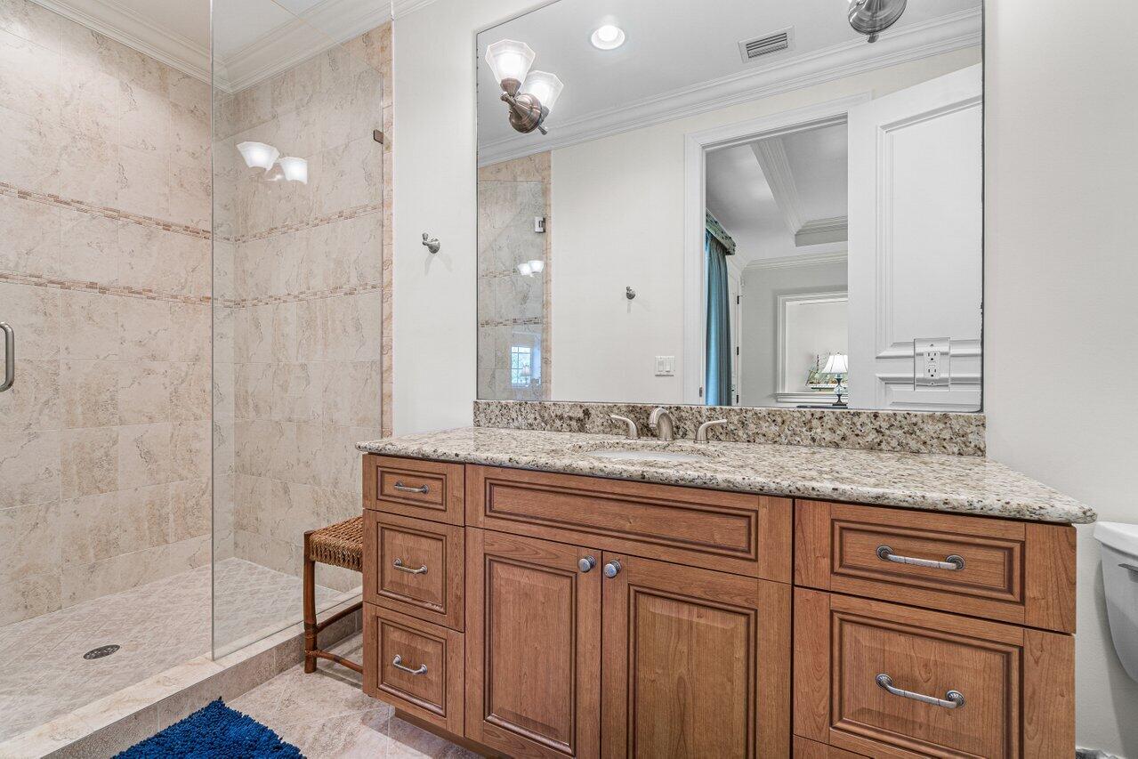6103 North Ocean Boulevard Ocean Ridge, FL 33435 - Photo 42 of 53 a bathroom with a granite countertop sink a mirror and a shower