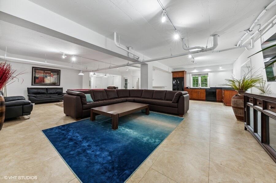 6103 North Ocean Boulevard Ocean Ridge, FL 33435 - Photo 44 of 53 a living room with furniture and a flat screen tv
