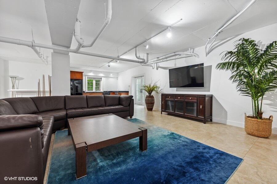 6103 North Ocean Boulevard Ocean Ridge, FL 33435 - Photo 45 of 53 a living room with furniture a flat screen tv and a fireplace