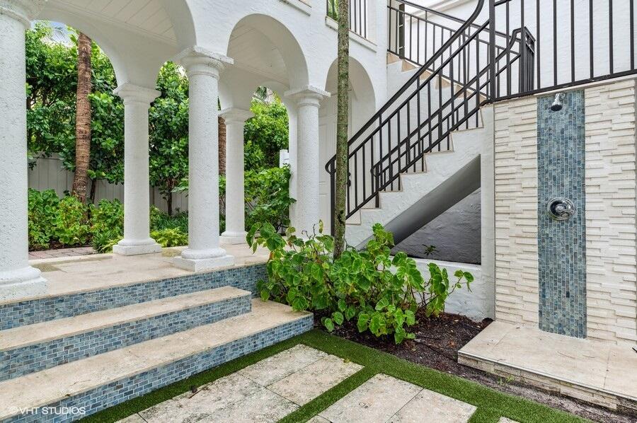 6103 North Ocean Boulevard Ocean Ridge, FL 33435 - Photo 50 of 53 a view of a house with large windows and flower plants