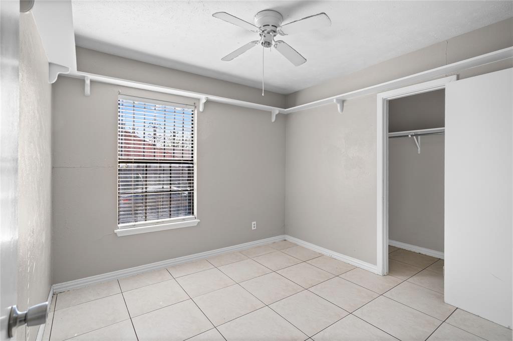 9319 Rutherglen Drive Dallas, TX 75227 - Photo 11 of 20 a view of an empty room with a window and chandelier fan