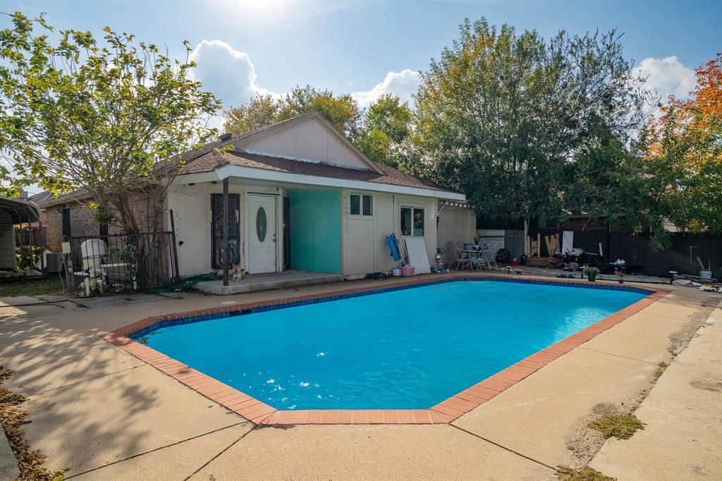 9319 Rutherglen Drive Dallas, TX 75227 - Photo 18 of 20 a view of a house with swimming pool and sitting area
