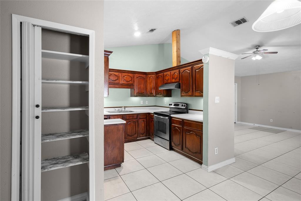 9319 Rutherglen Drive Dallas, TX 75227 - Photo 4 of 20 a kitchen with stainless steel appliances granite countertop a refrigerator and a stove top oven
