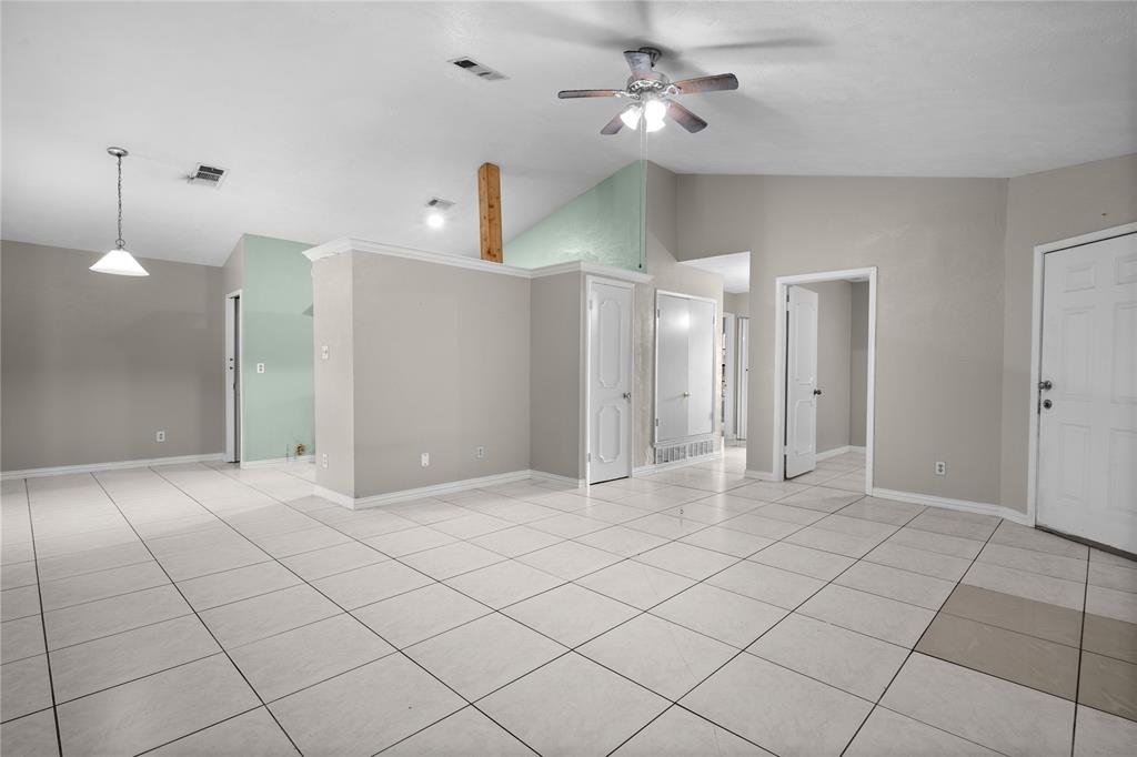 9319 Rutherglen Drive Dallas, TX 75227 - Photo 6 of 20 a view of a livingroom with a chandelier fan and kitchen view