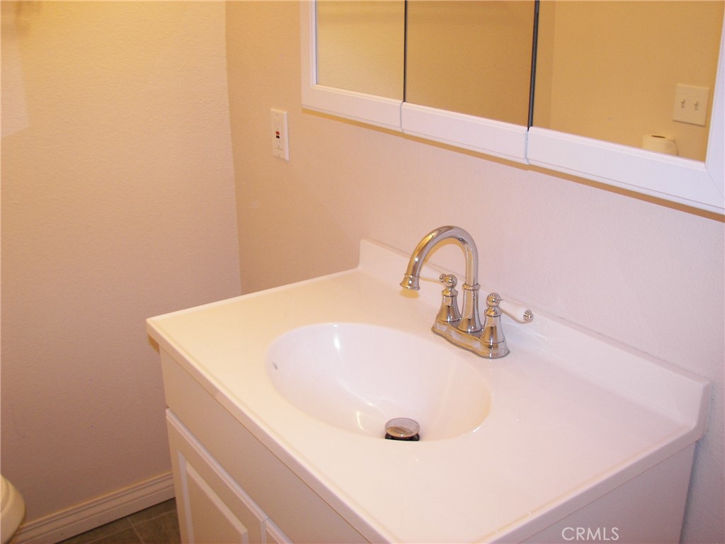 24977 Crest Forest Drive Crestline, CA 92325 - Photo 11 of 28 a close view of a sink and tap