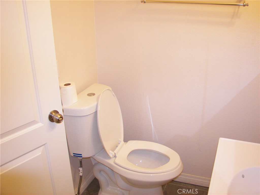24977 Crest Forest Drive Crestline, CA 92325 - Photo 12 of 28 a white toilet sitting next to a white tub