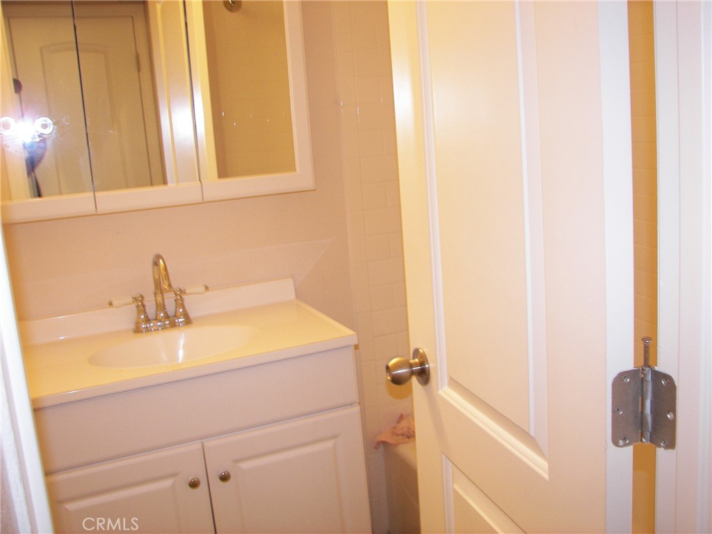 24977 Crest Forest Drive Crestline, CA 92325 - Photo 13 of 28 a bathroom with a sink and a mirror