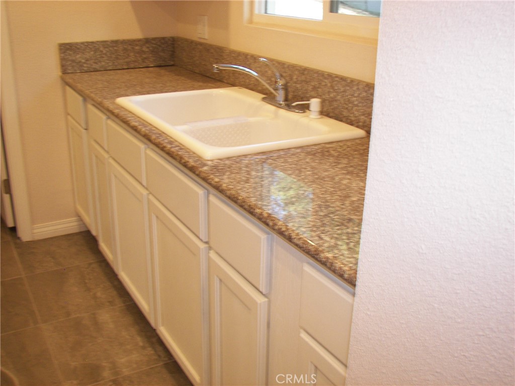 24977 Crest Forest Drive Crestline, CA 92325 - Photo 16 of 28 a bathroom with a granite countertop sink and a mirror