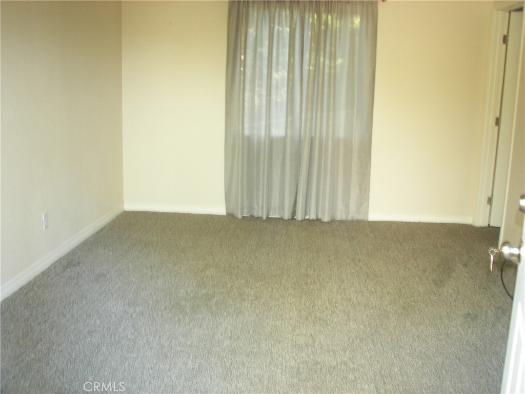 24977 Crest Forest Drive Crestline, CA 92325 - Photo 2 of 28 an empty room with a door