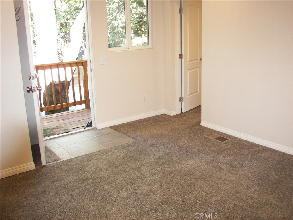 24977 Crest Forest Drive Crestline, CA 92325 - Photo 9 of 28 an empty room with windows