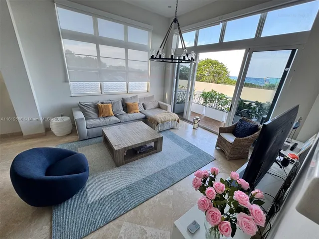 a living room with furniture and a floor to ceiling window