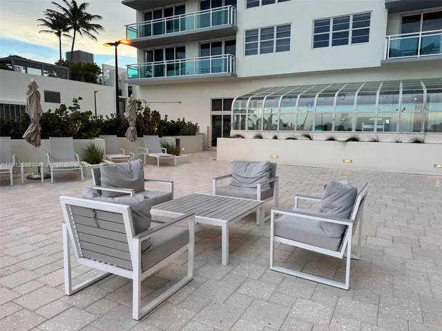 a view of a patio with couches table and chairs