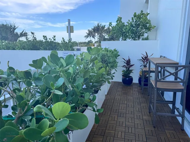 a view of a balcony with chairs