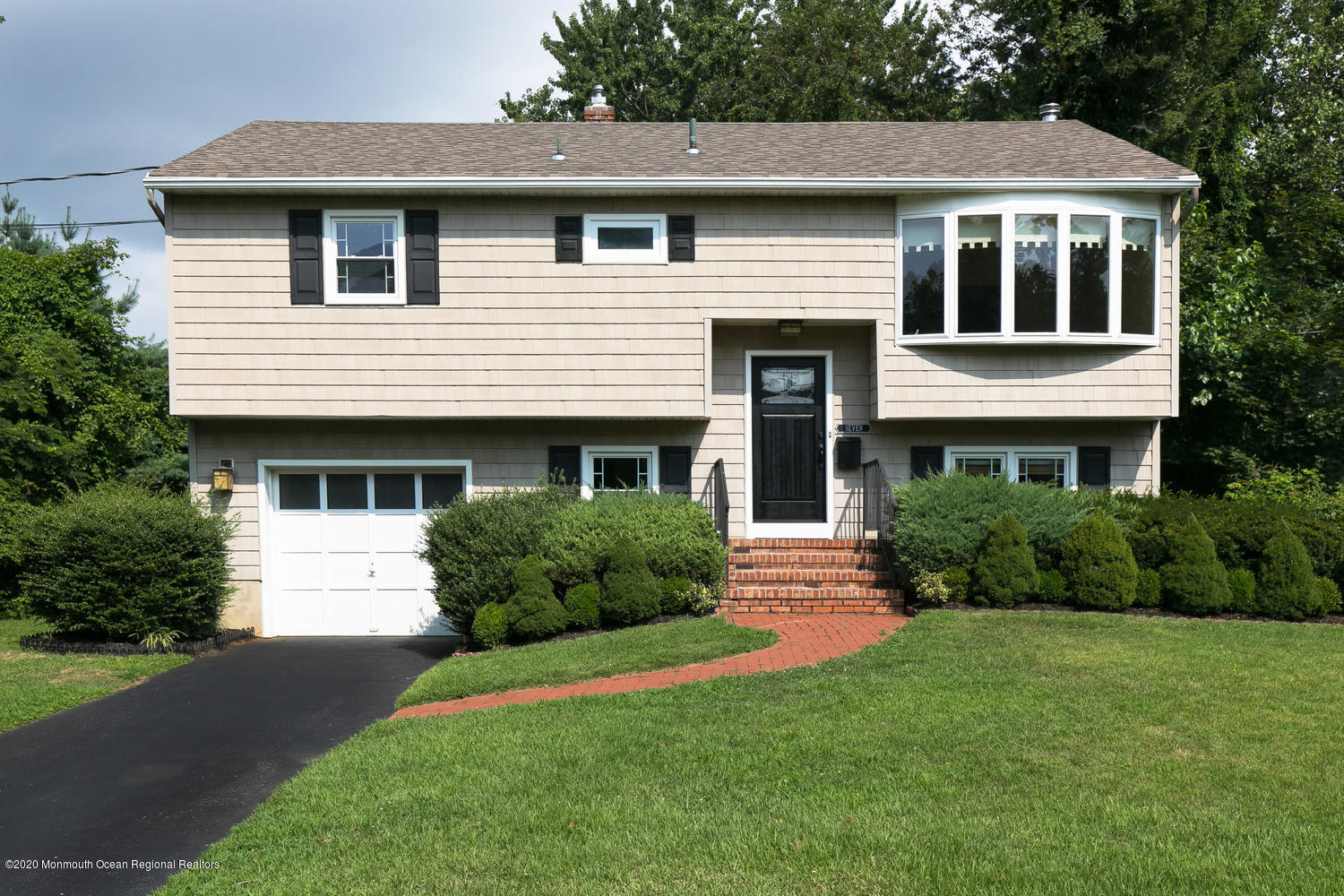 7 Hendrickson Place Fair Haven, NJ 07704 - Photo 2 of 14 a front view of a house with a yard and garage