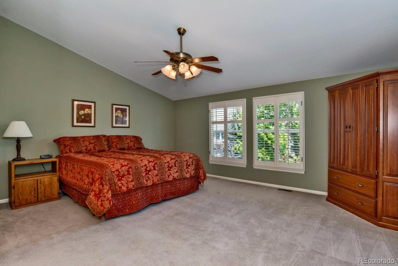 1757 Spring Water Place Highlands Ranch, CO 80129 - Photo 15 of 34 a spacious bedroom with a bed and a chandelier