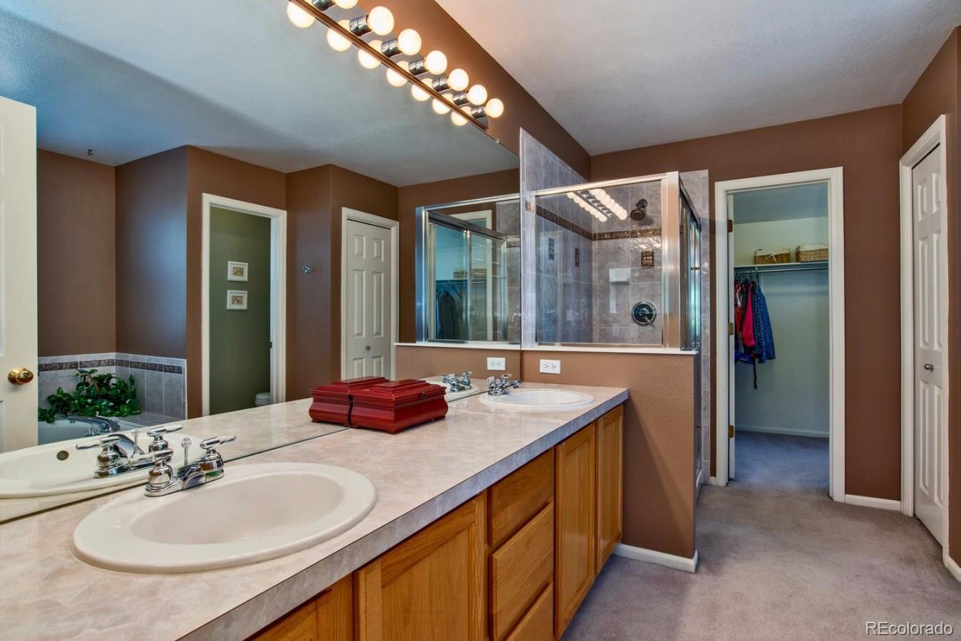 1757 Spring Water Place Highlands Ranch, CO 80129 - Photo 16 of 34 a bathroom with a granite countertop sink and a mirror