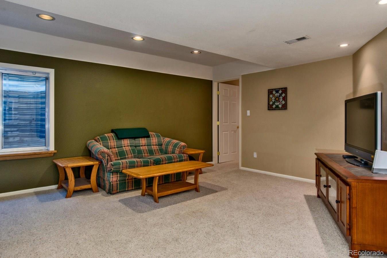1757 Spring Water Place Highlands Ranch, CO 80129 - Photo 23 of 34 a bedroom with furniture and a flat screen tv