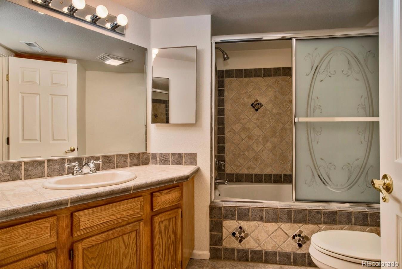1757 Spring Water Place Highlands Ranch, CO 80129 - Photo 26 of 34 a bathroom with a sink and a mirror