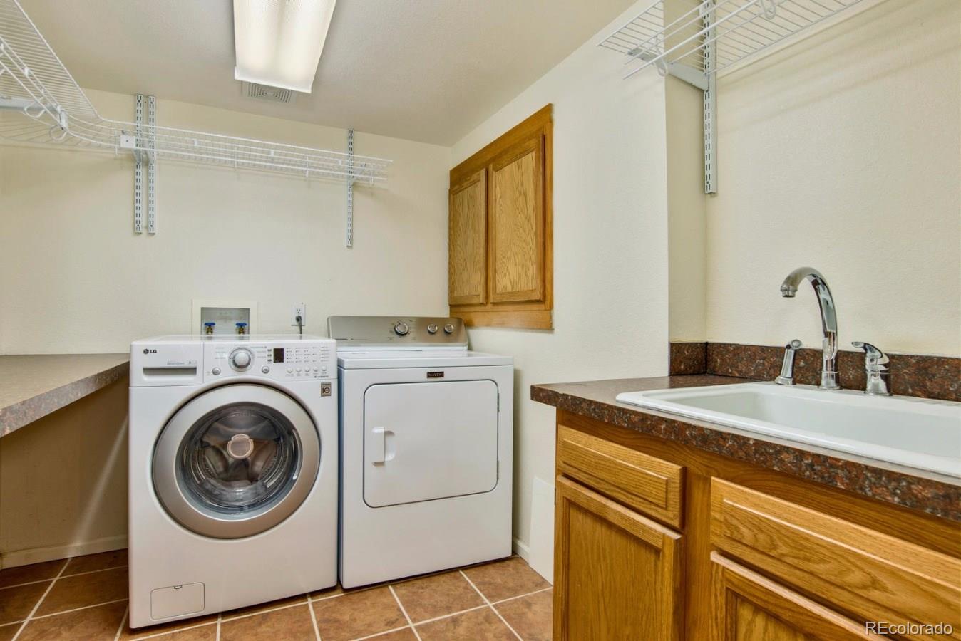 1757 Spring Water Place Highlands Ranch, CO 80129 - Photo 27 of 34 a utility room with sink dryer and washer
