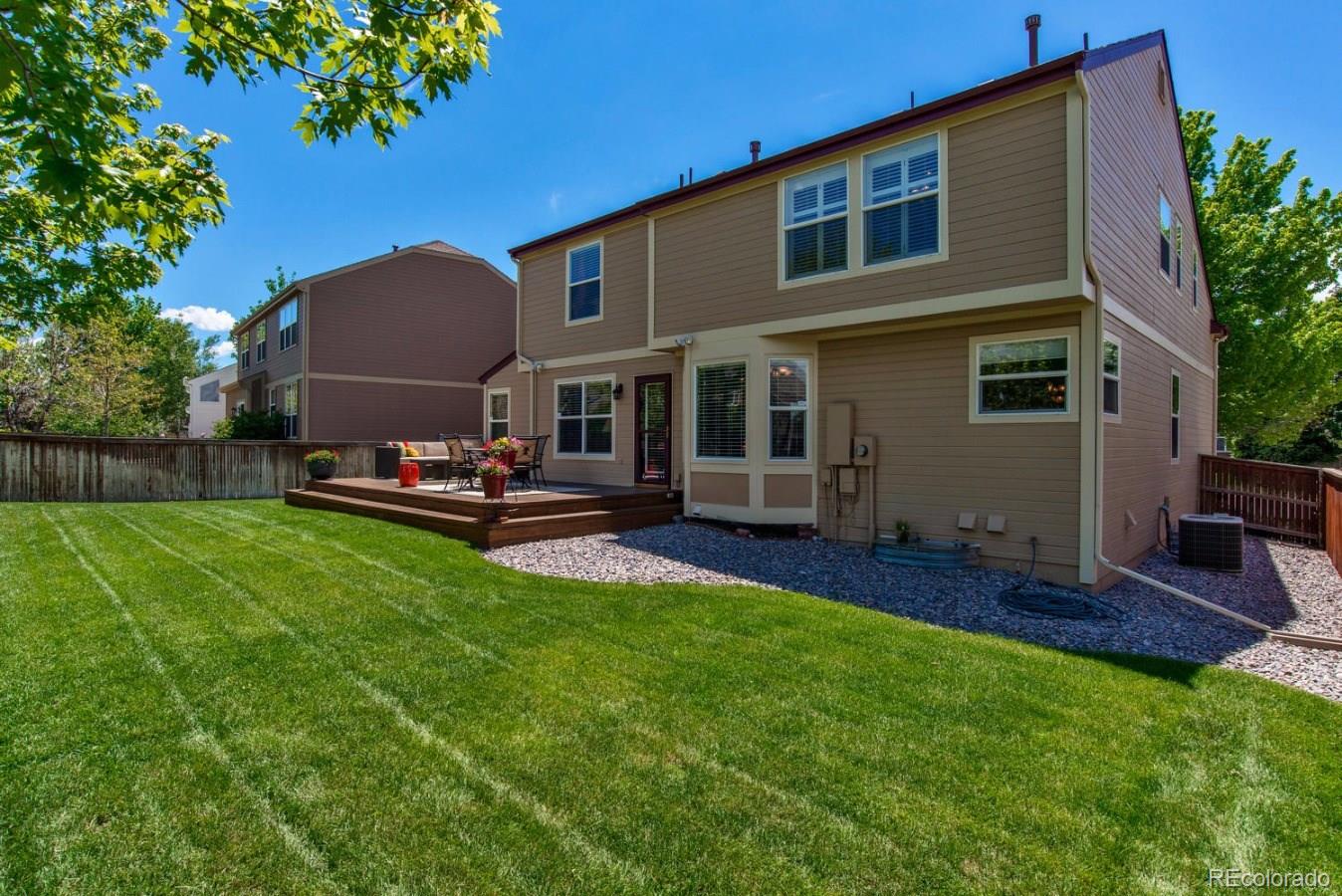 1757 Spring Water Place Highlands Ranch, CO 80129 - Photo 30 of 34 a front view of house with yard and outdoor seating