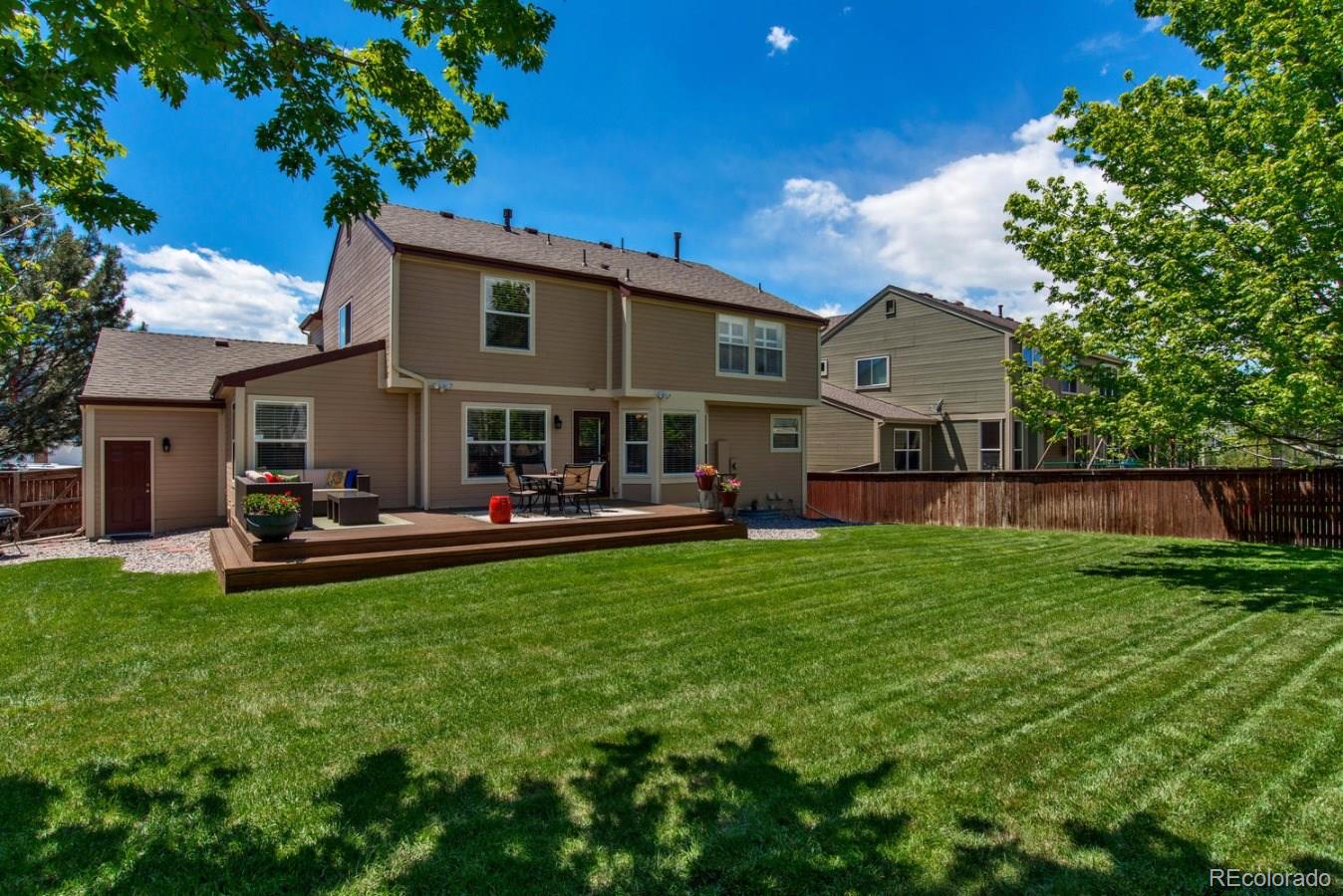 1757 Spring Water Place Highlands Ranch, CO 80129 - Photo 31 of 34 a view of a house with a yard and sitting area