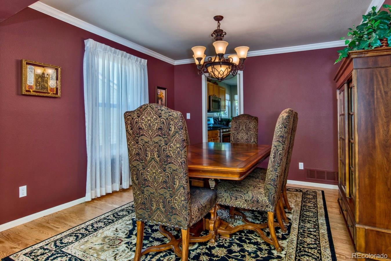1757 Spring Water Place Highlands Ranch, CO 80129 - Photo 5 of 34 a dining room with furniture and chandelier