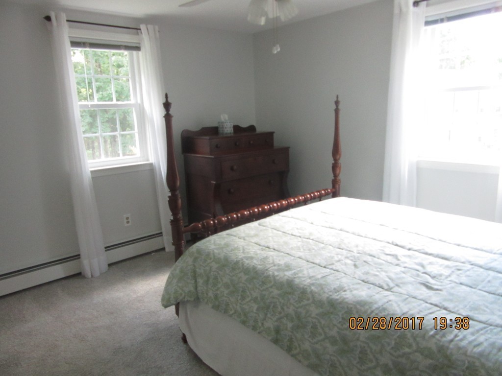 77 Autumn Road Lunenburg, MA 01462 - Photo 17 of 21 a bed sitting in a bedroom next to a window