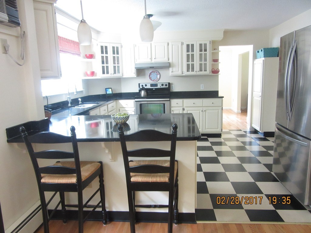 77 Autumn Road Lunenburg, MA 01462 - Photo 10 of 21 a kitchen with a checkered floor and white cabinets