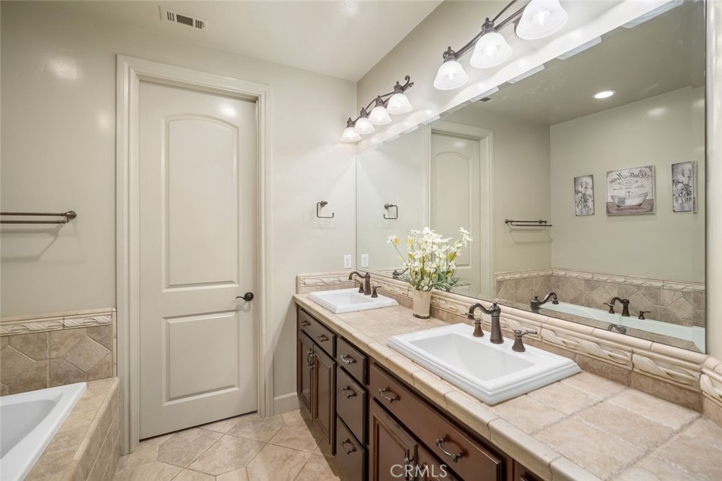 1602 Payton Way Nipomo, CA 93444 - Photo 27 of 71 a bathroom with a sink double vanity granite tub and shower