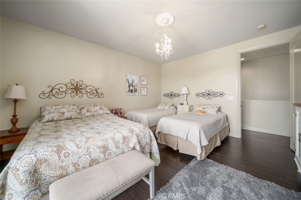 1602 Payton Way Nipomo, CA 93444 - Photo 32 of 71 a bedroom with two beds and a chandelier