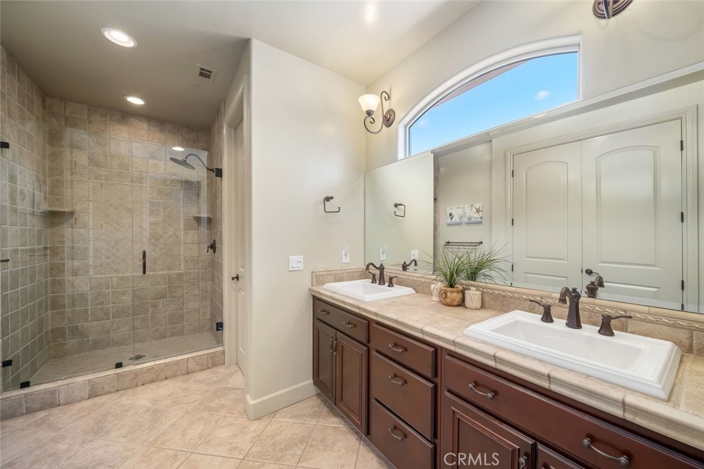 1602 Payton Way Nipomo, CA 93444 - Photo 33 of 71 a bathroom with a shower sink and mirror