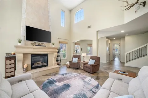 a dining hall with stainless steel appliances kitchen island granite countertop a table and chairs in it