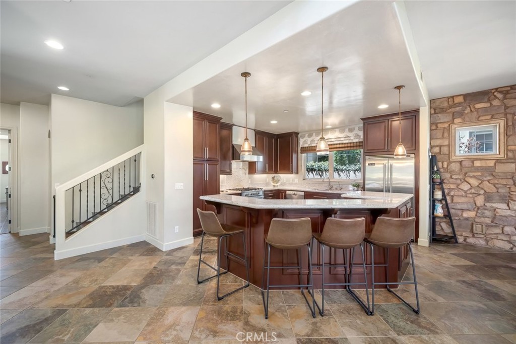 1602 Payton Way Nipomo, CA 93444 - Photo 9 of 71 a dining hall with stainless steel appliances kitchen island granite countertop a table and chairs in it